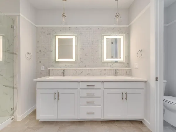a bathroom with a sink a vanity a large mirror and a window