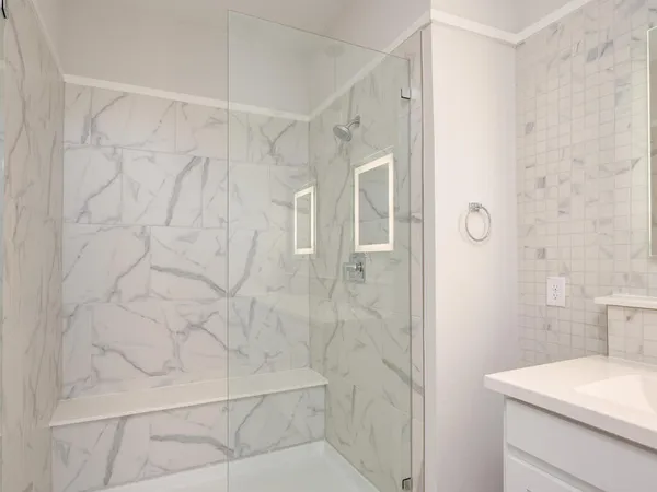 a bathroom with a shower and a sink