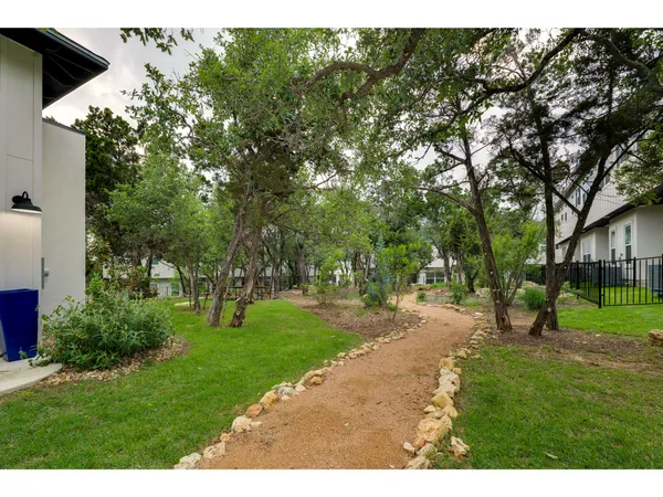 a garden with trees in front of it