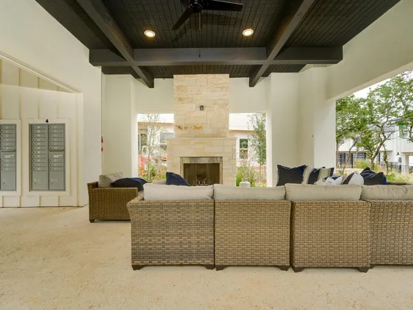 a living room with furniture a fireplace and a large window