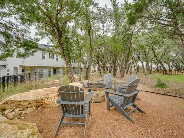 a view of a house with backyard and sitting area