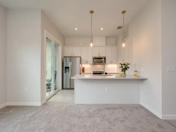 a kitchen with stainless steel appliances a sink stove and refrigerator