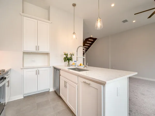 a kitchen that has a sink a stove and a refrigerator