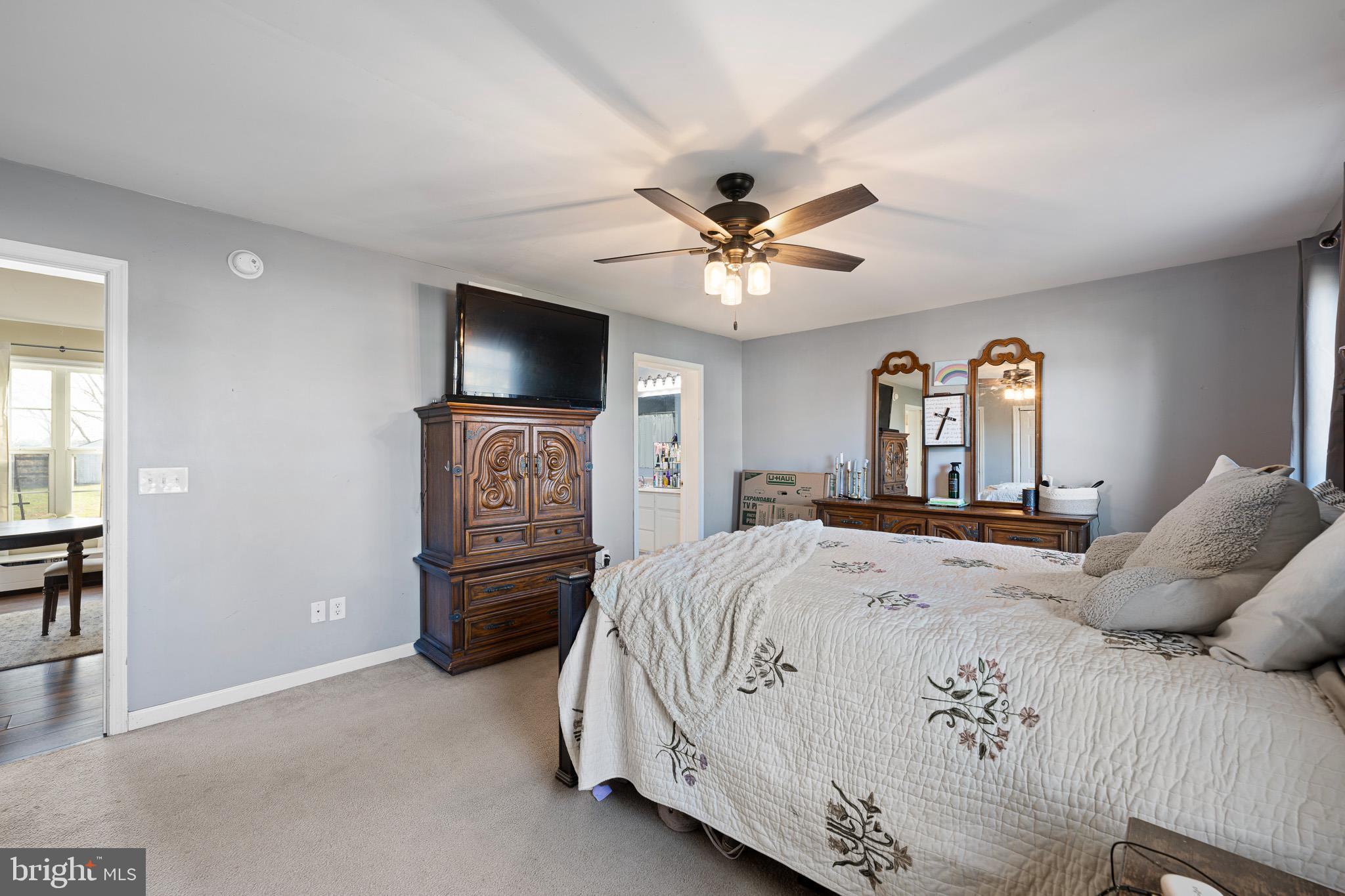 29 East Walnut Street Magnolia, DE 19962 - Photo 13 of 35 a bedroom with a bed and a chandelier