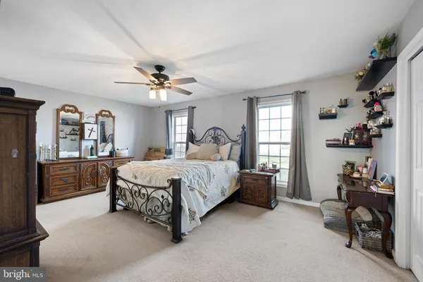 a spacious bedroom with a bed and a chandelier