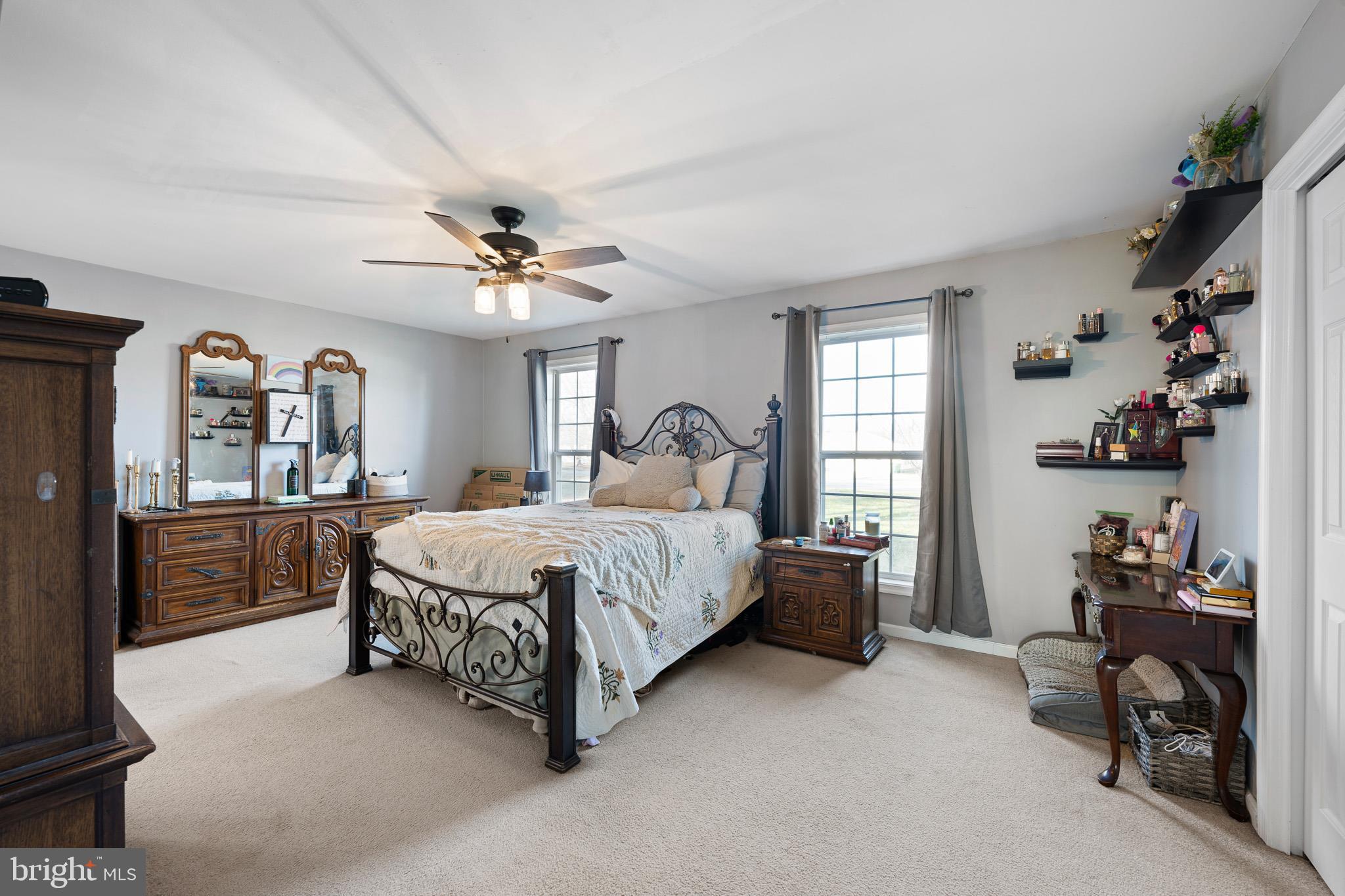 29 East Walnut Street Magnolia, DE 19962 - Photo 14 of 35 a spacious bedroom with a bed and a chandelier
