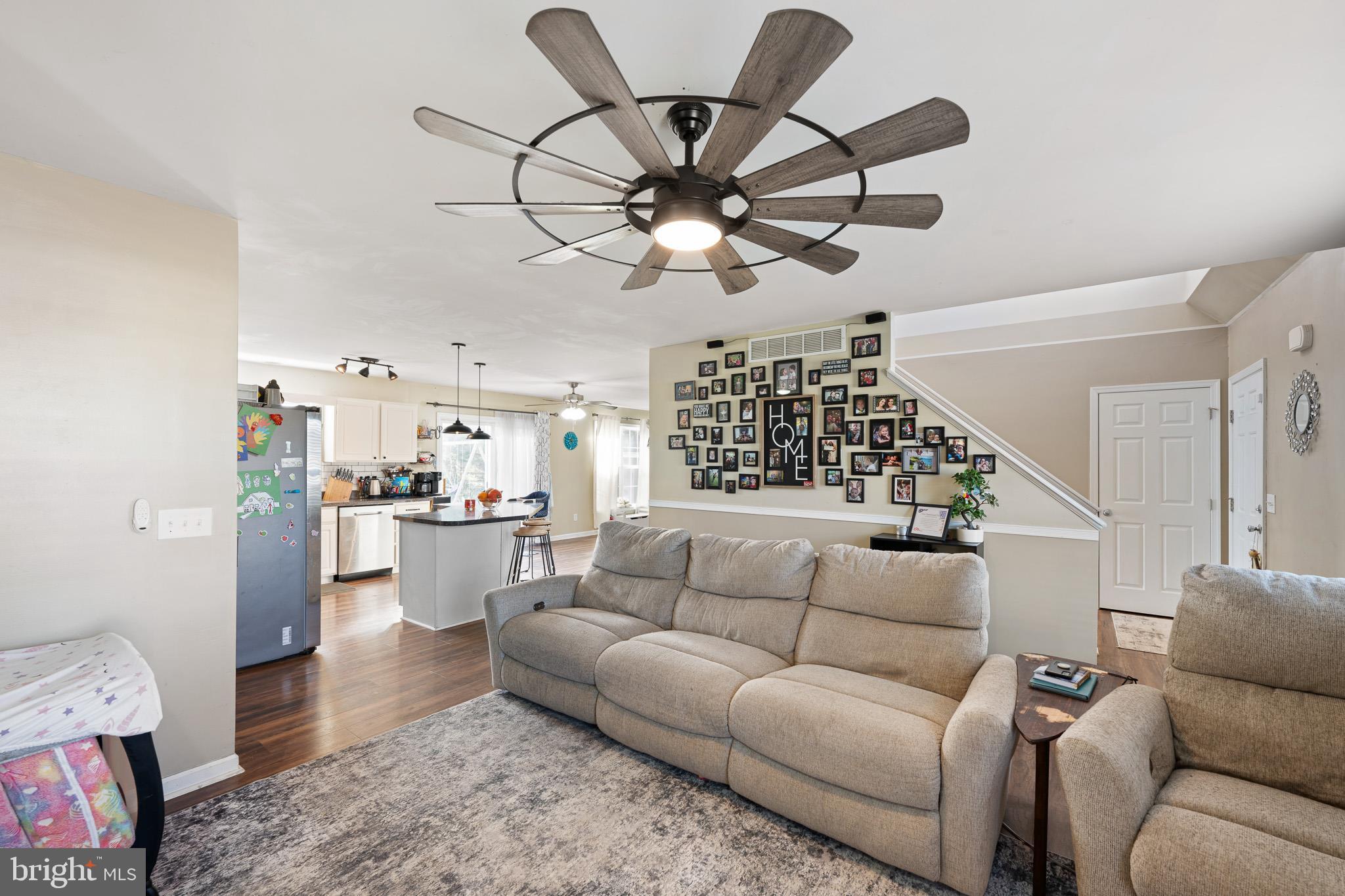 29 East Walnut Street Magnolia, DE 19962 - Photo 4 of 35 a living room with furniture a ceiling fan and a rug