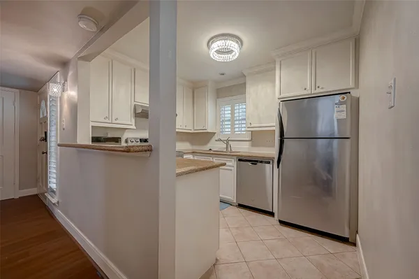 a kitchen with a refrigerator and a sink