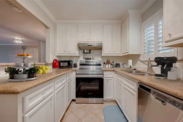 a kitchen with a sink cabinets and stainless steel appliances