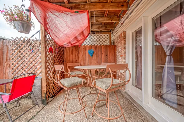 a view of a chairs and table in the balcony