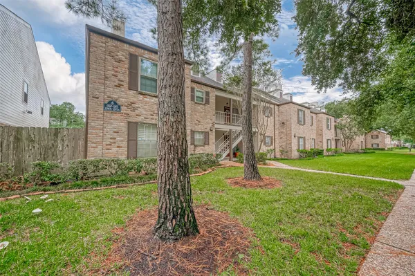 a garden with trees in front of it