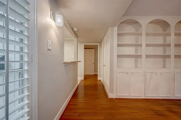 a view of a hallway with wooden floor and entryway