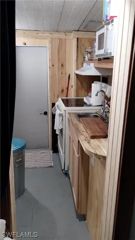 a kitchen with stove cabinets and a sink