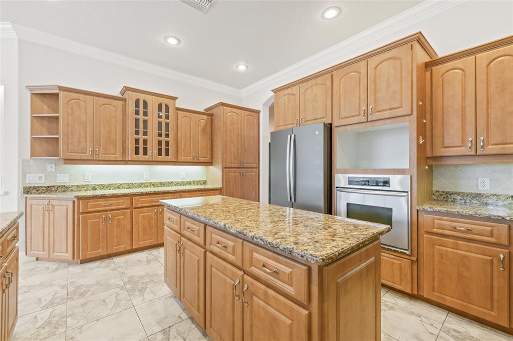 11040 Fulton Avenue Weeki Wachee, FL 34613 - Photo 15 of 77 a kitchen with stainless steel appliances granite countertop a refrigerator sink and cabinets