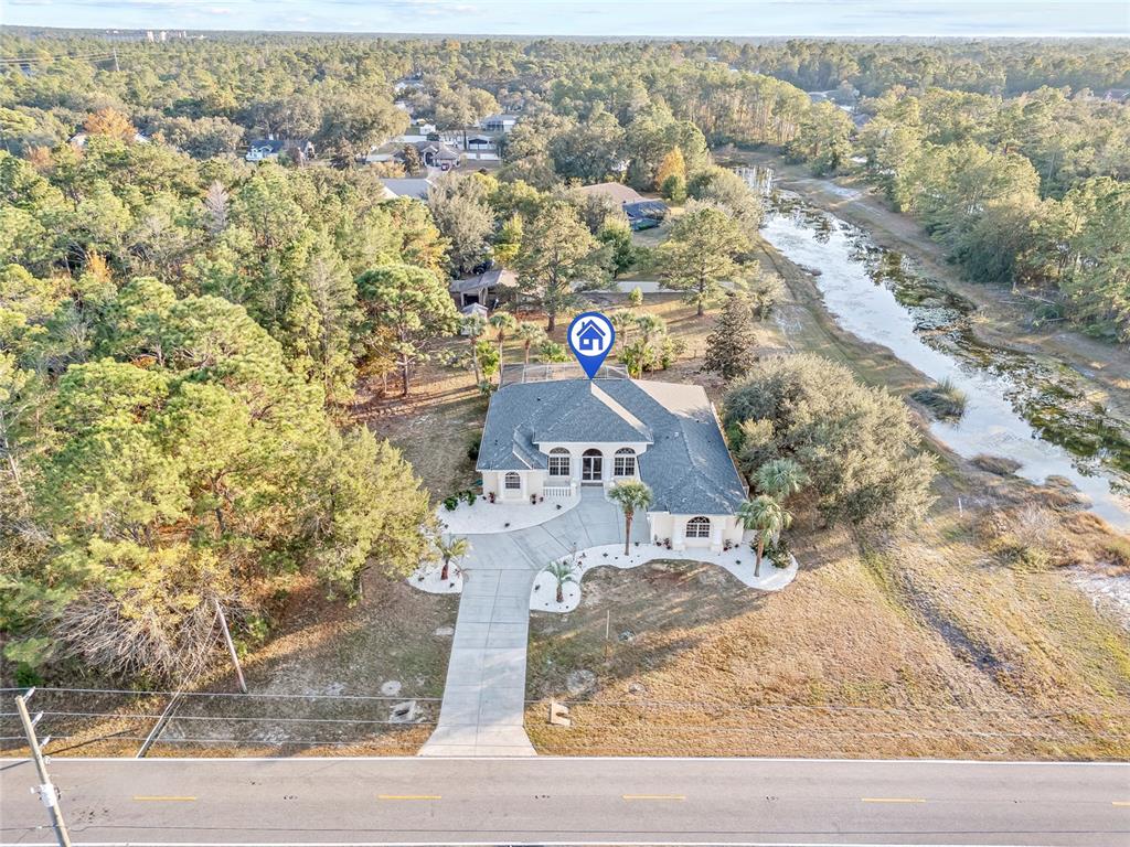 11040 Fulton Avenue Weeki Wachee, FL 34613 - Photo 2 of 77 an aerial view of a house with a yard
