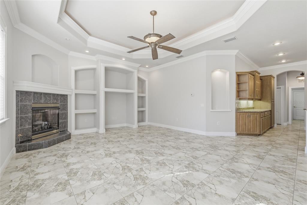 11040 Fulton Avenue Weeki Wachee, FL 34613 - Photo 23 of 77 a view of an empty room with a fireplace and a window