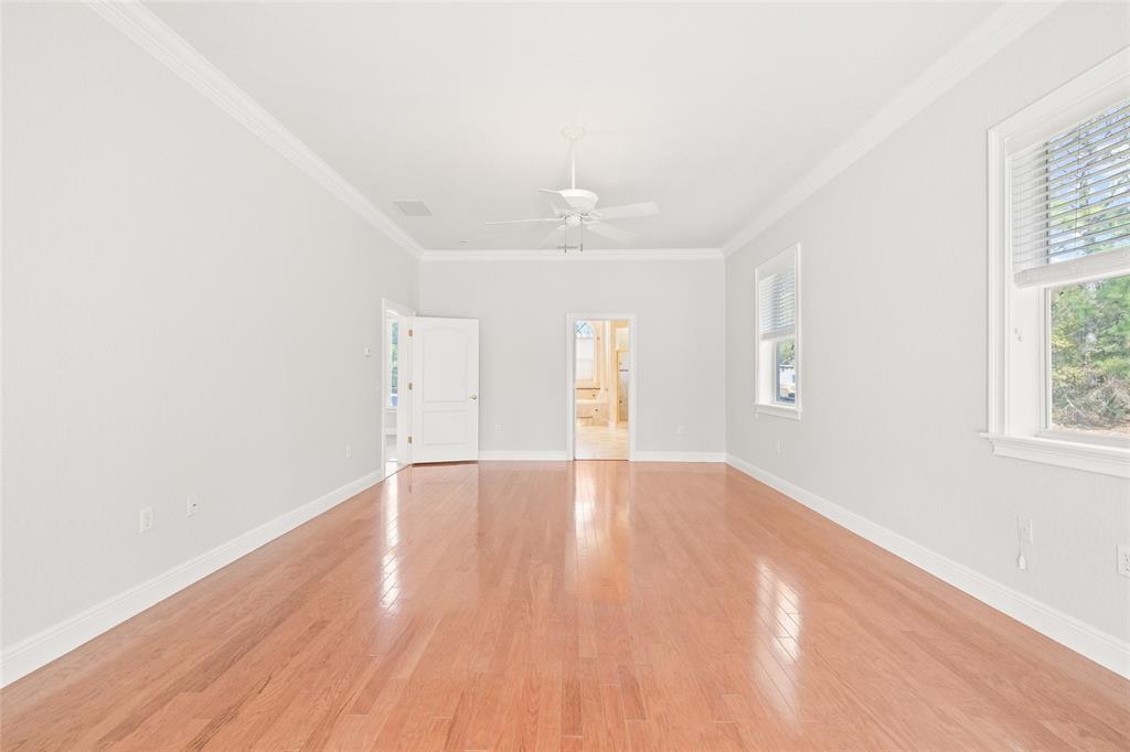 11040 Fulton Avenue Weeki Wachee, FL 34613 - Photo 28 of 77 an empty room with wooden floor and windows