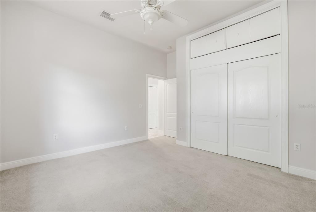 11040 Fulton Avenue Weeki Wachee, FL 34613 - Photo 44 of 77 an empty room with a ceiling fan and a window