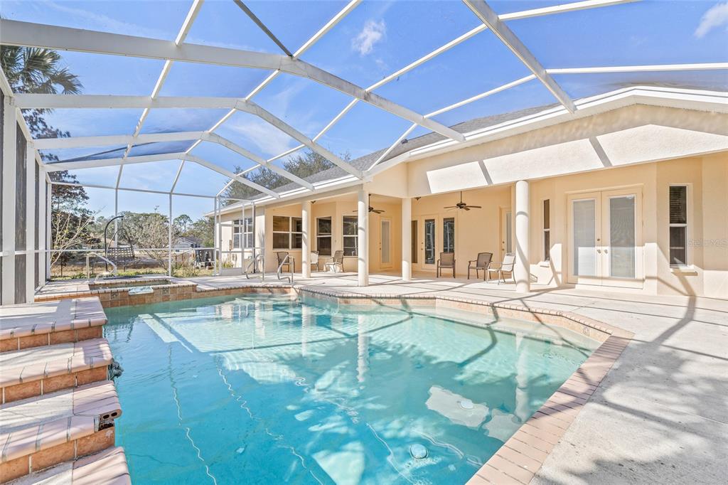 11040 Fulton Avenue Weeki Wachee, FL 34613 - Photo 49 of 77 a view of a swimming pool with outdoor seating