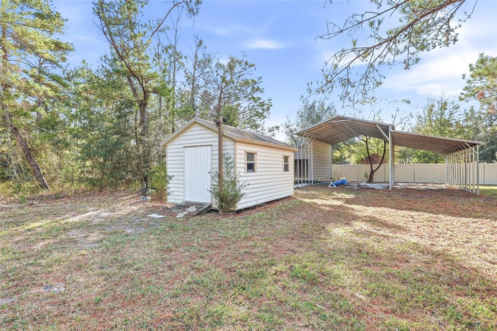 11040 Fulton Avenue Weeki Wachee, FL 34613 - Photo 54 of 77 a view of a house with backyard and a tree