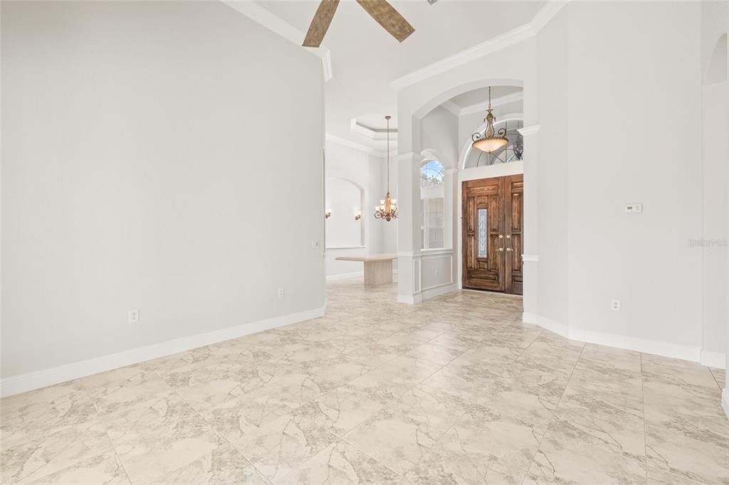 11040 Fulton Avenue Weeki Wachee, FL 34613 - Photo 7 of 77 an empty room with chandelier fan and closet