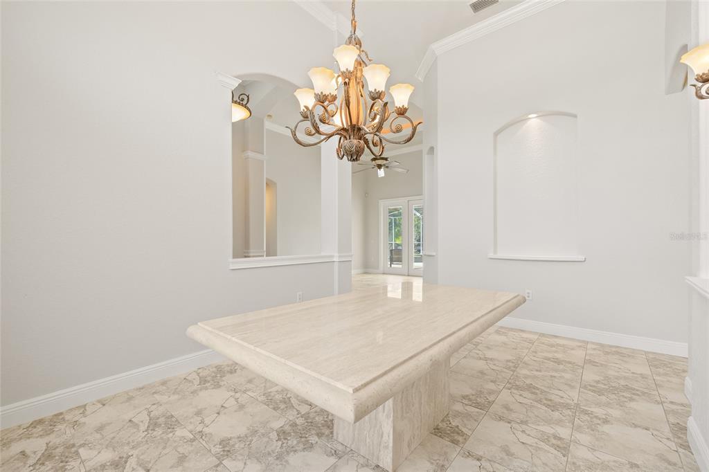 11040 Fulton Avenue Weeki Wachee, FL 34613 - Photo 10 of 77 a view of a room with a chandelier fan and wooden floor