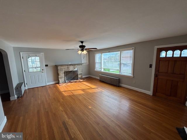 3149 Carlisle Road Dover, PA 17315 - Photo 2 of 10 an empty room with windows fireplace and wooden floor