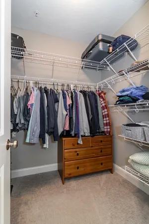 a view of walk in closet with clothes