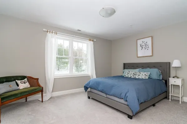 a bedroom with a bed and window