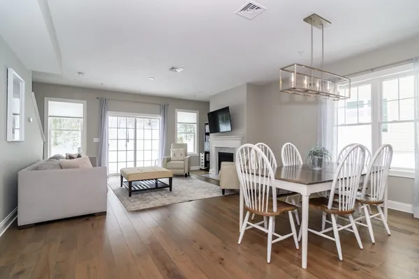 a view of a dining room with furniture window and wooden floor