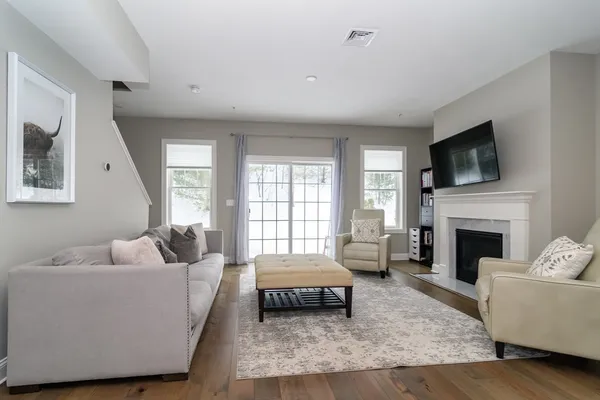 a living room with furniture and a fireplace