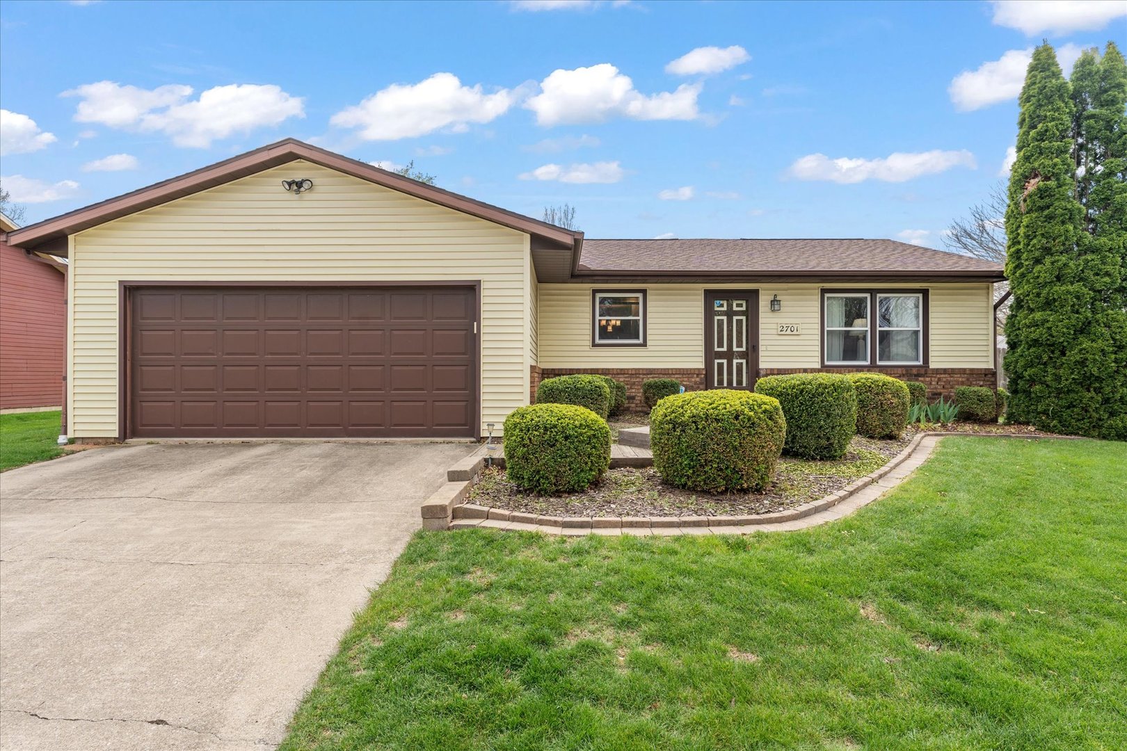 a front view of a house with a yard and garage