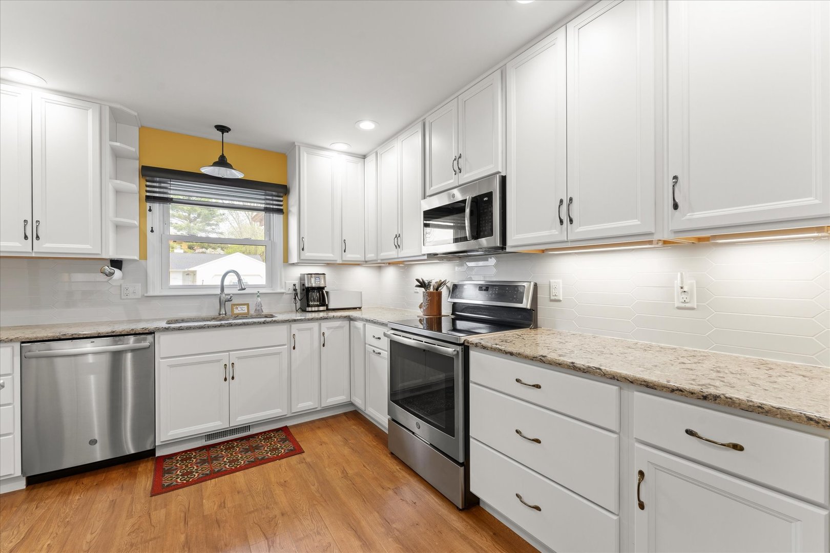 2701 Hathaway Drive Champaign, IL 61821 - Photo 7 of 22 a kitchen with granite countertop white cabinets and white appliances