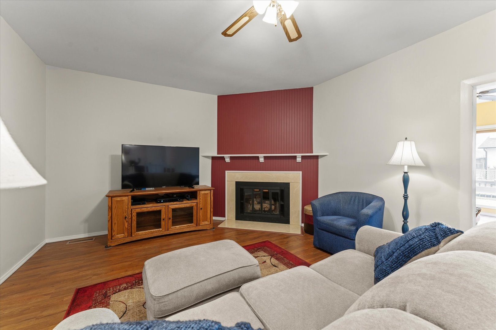 2701 Hathaway Drive Champaign, IL 61821 - Photo 9 of 22 a living room with furniture a fireplace and a flat screen tv