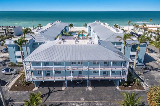 a roof deck with table and chairs