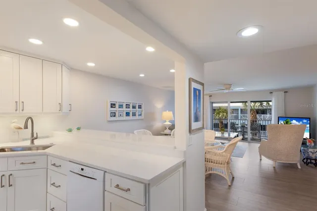 a large white kitchen with a large window