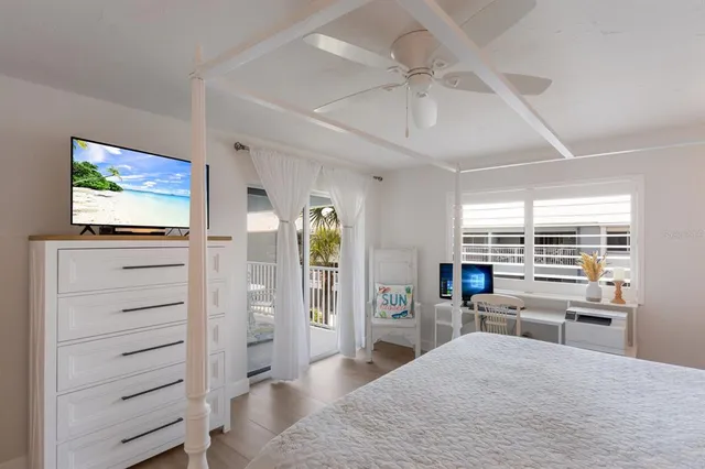 a room with a bed and a flat screen tv