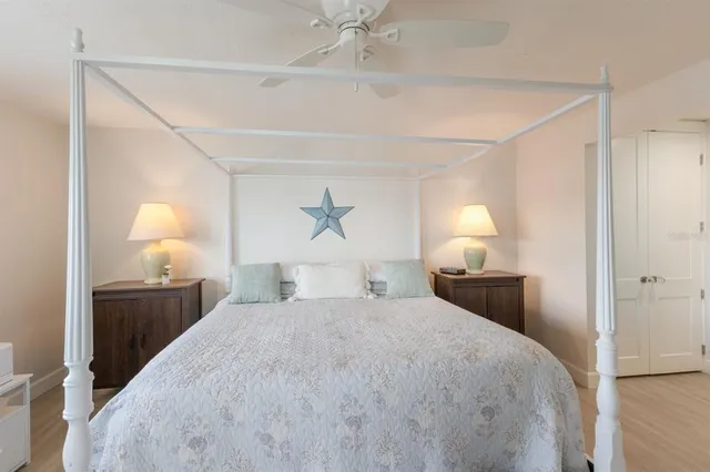 a bedroom with a bed and a lamp