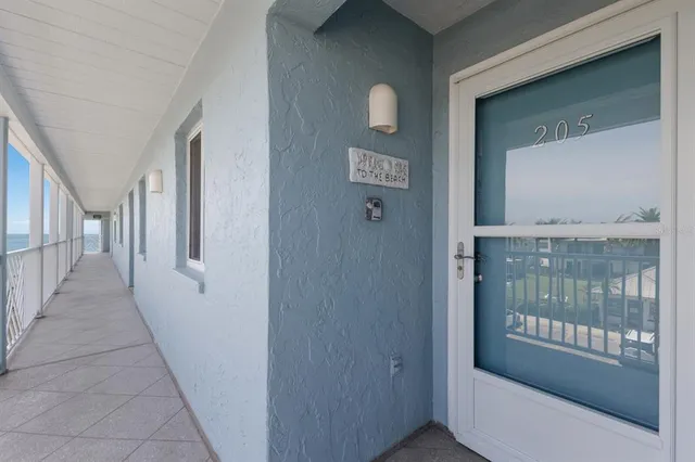 a view of a hallway with a glass door and stairs