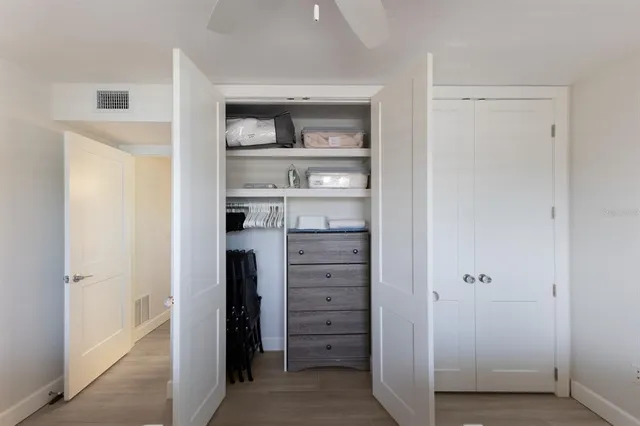a view of walk in closet with empty racks