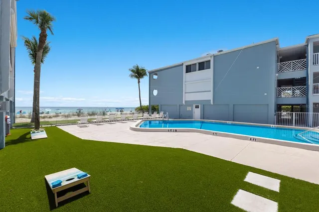 a view of a backyard with a table and chairs