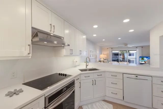a kitchen with a sink cabinets and appliances