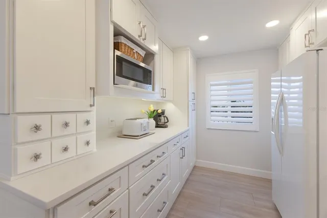 a kitchen with cabinets and window
