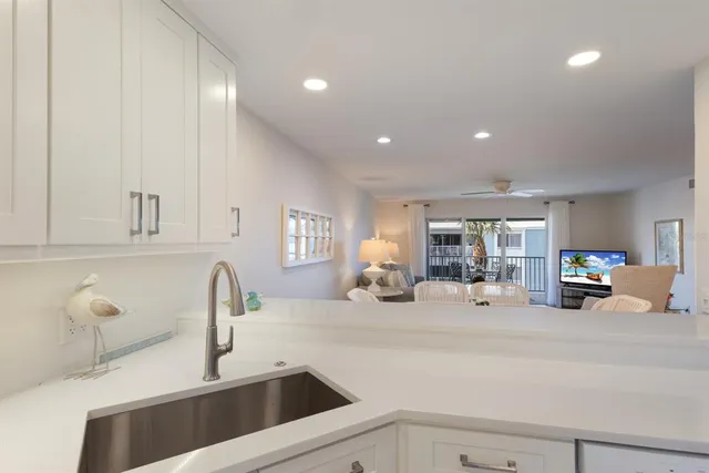 a kitchen with a sink and a stove top oven