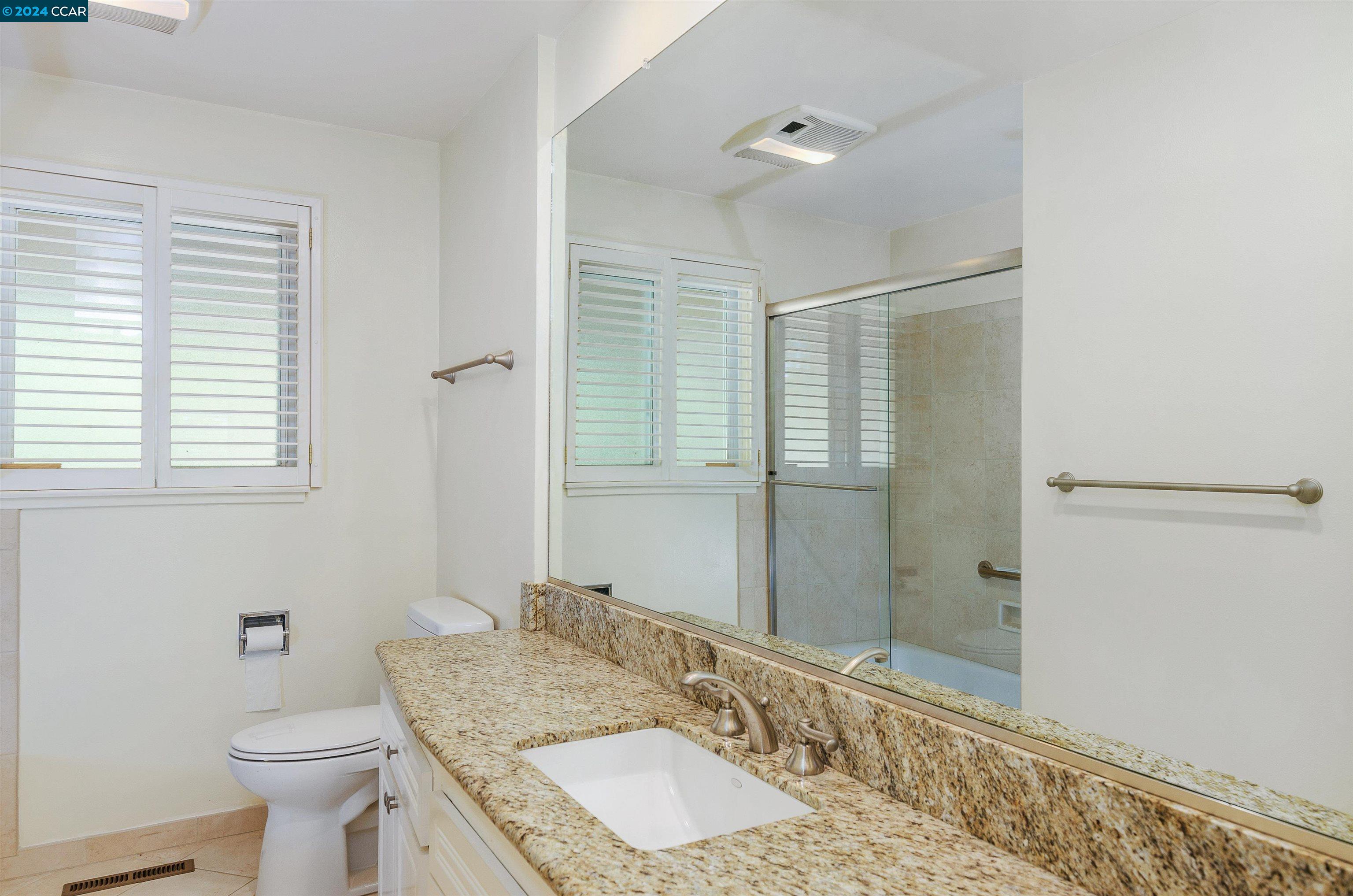 32 Diablo Circle Lafayette, CA 94549 - Photo 13 of 18 a bathroom with a granite countertop sink a toilet a mirror and shower