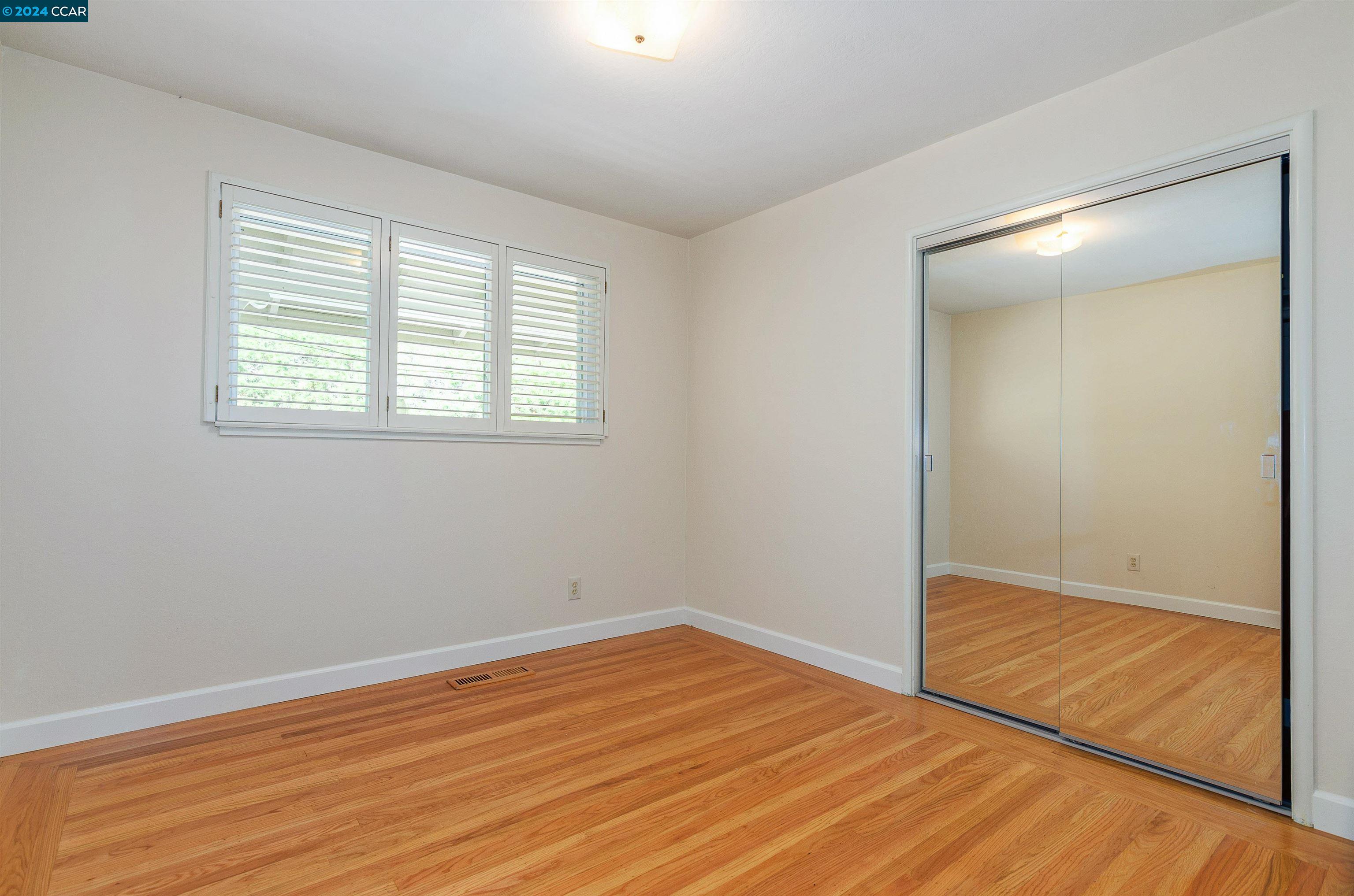 32 Diablo Circle Lafayette, CA 94549 - Photo 14 of 18 an empty room with wooden floor and windows