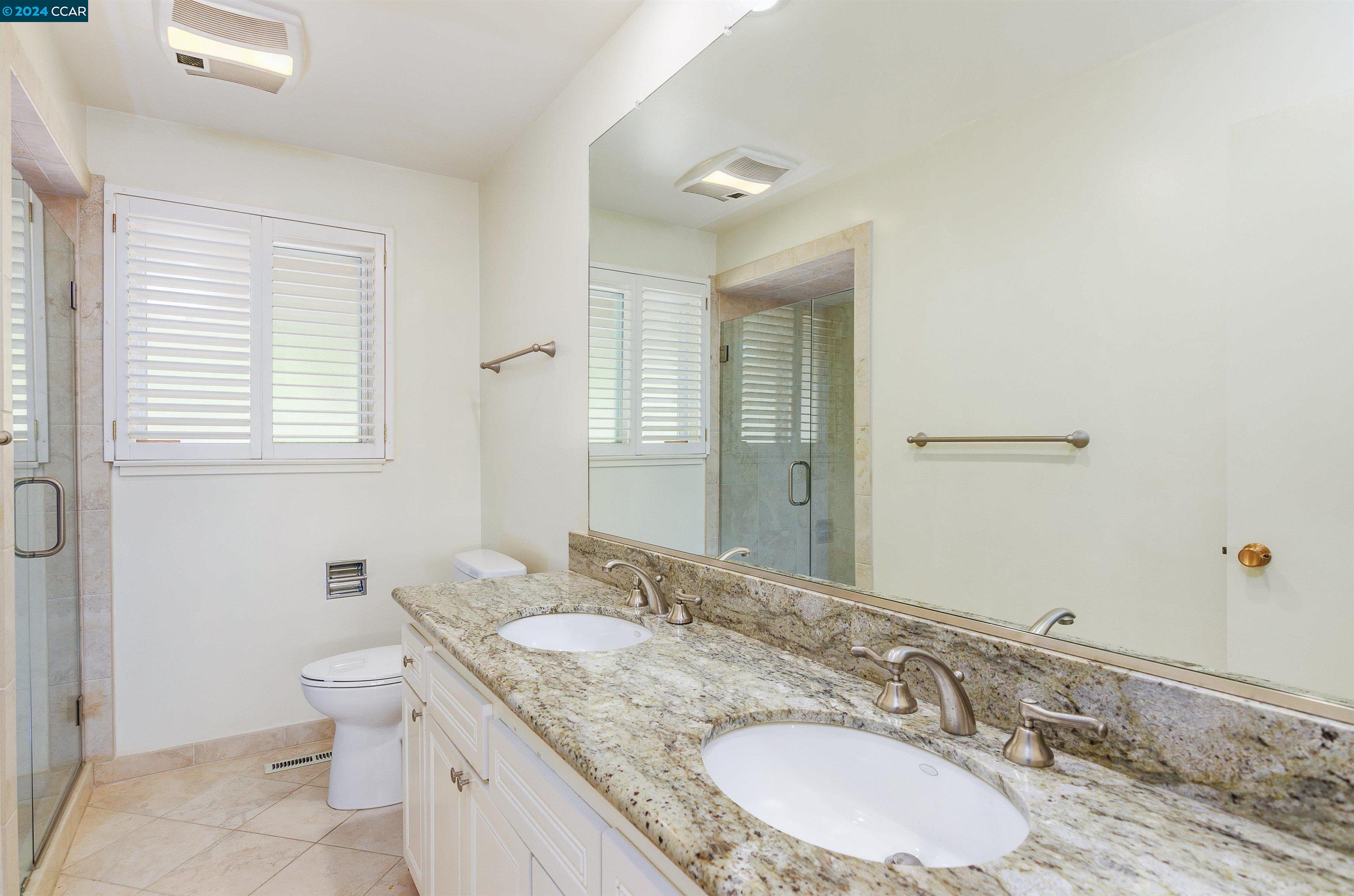 32 Diablo Circle Lafayette, CA 94549 - Photo 17 of 18 a bathroom with a granite countertop double vanity sink and a mirror