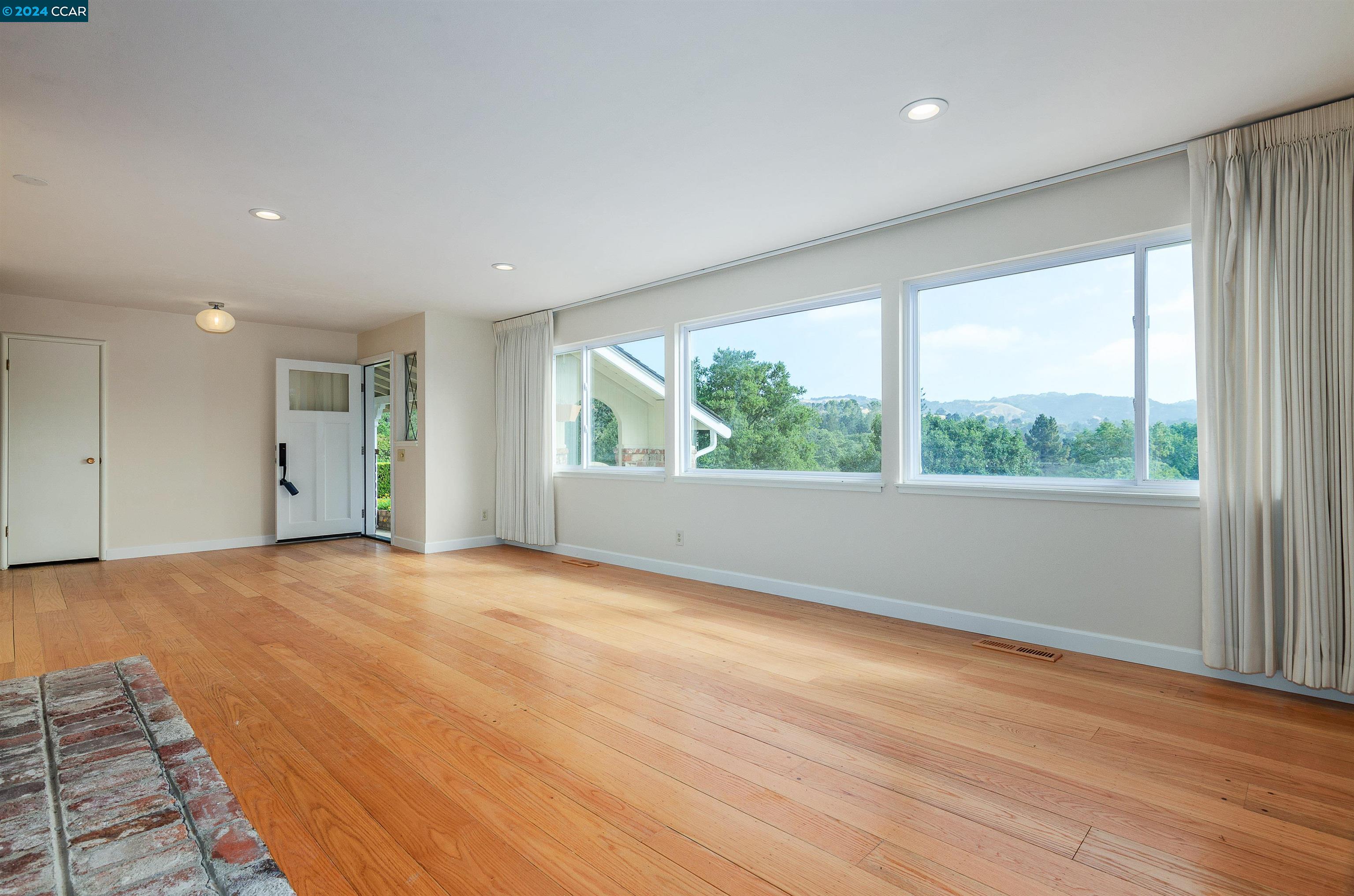 32 Diablo Circle Lafayette, CA 94549 - Photo 3 of 18 a view of an empty room with wooden floor and a window