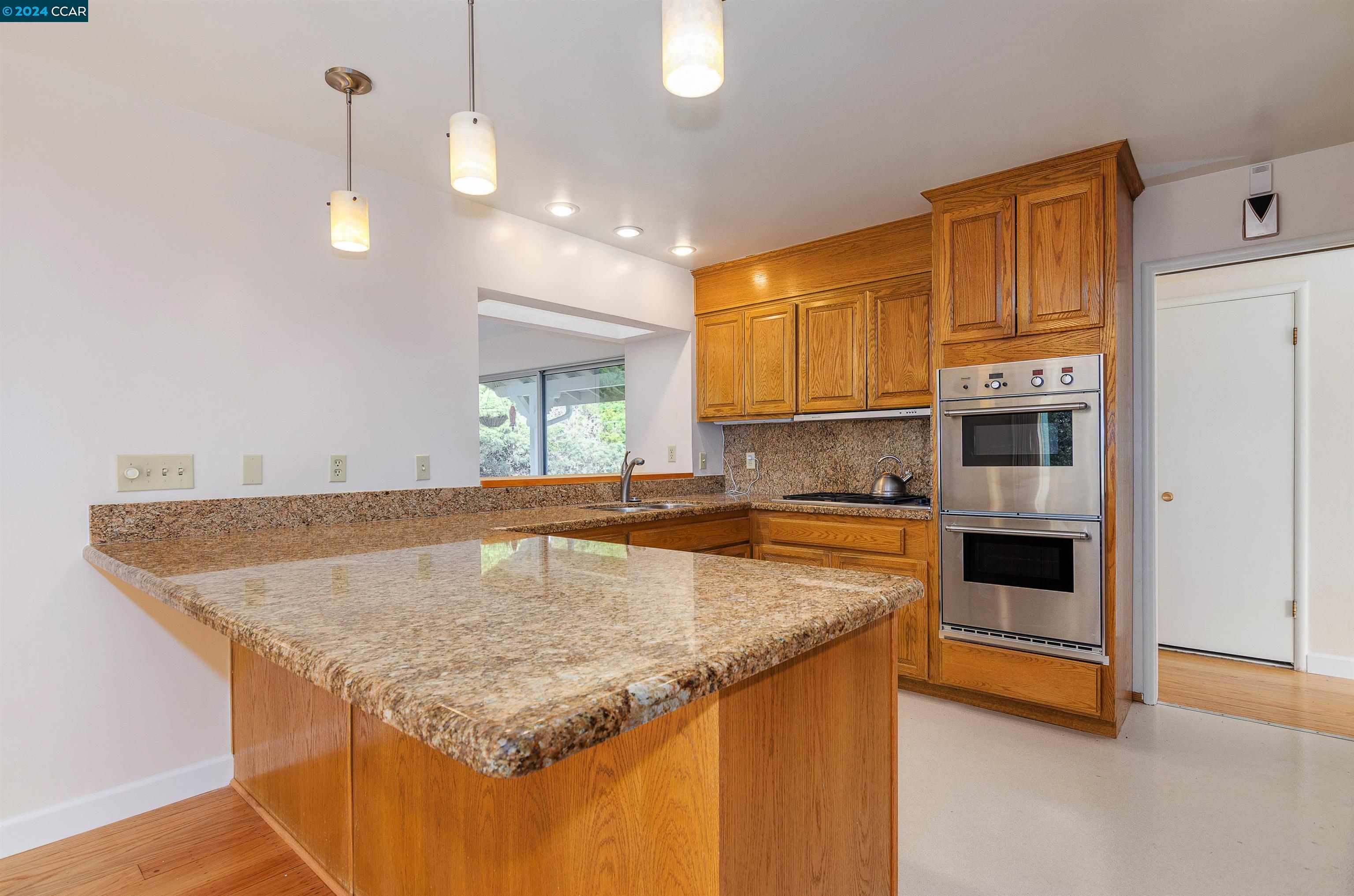32 Diablo Circle Lafayette, CA 94549 - Photo 7 of 18 a kitchen with granite countertop a stove and a sink