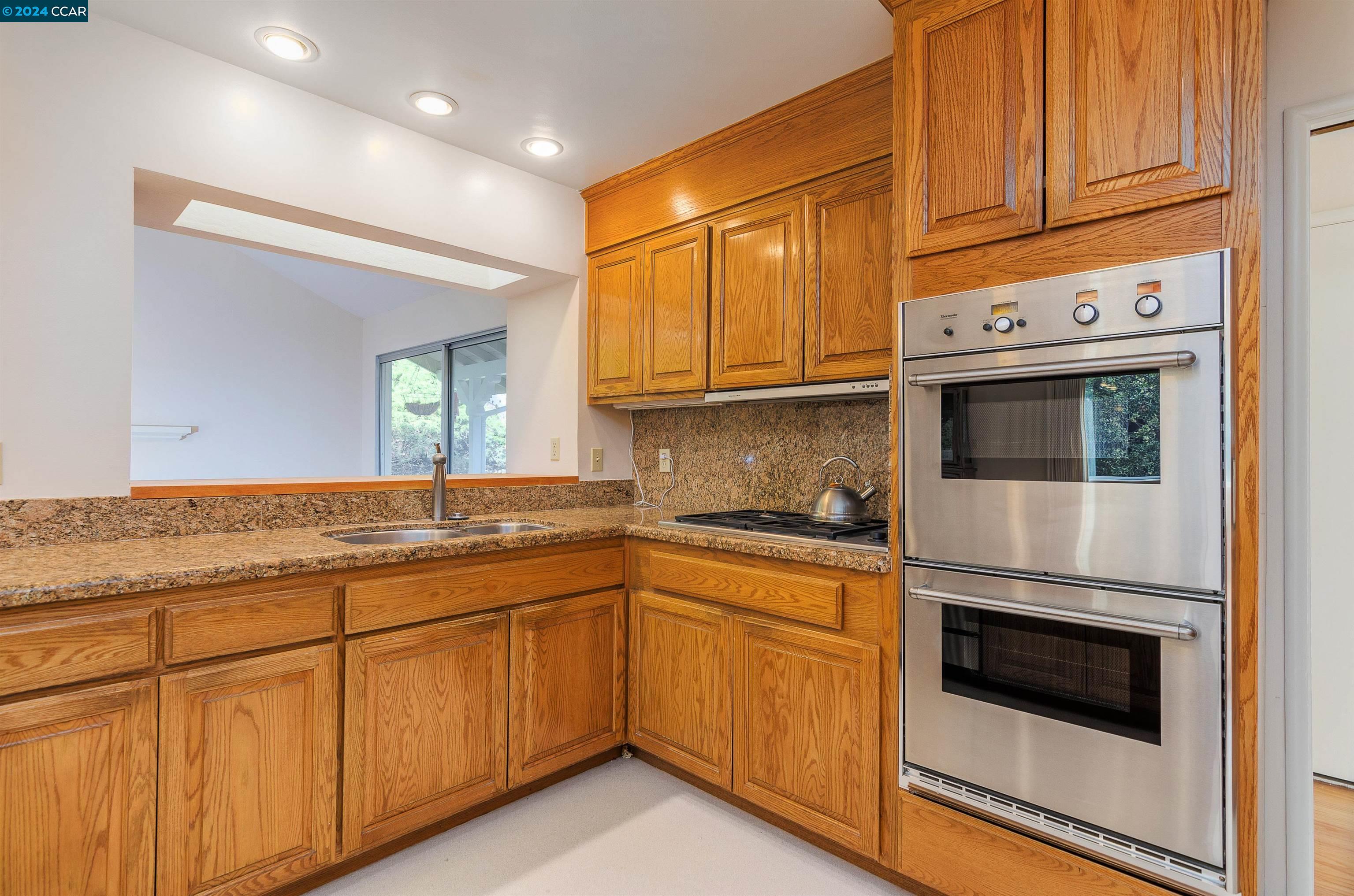 32 Diablo Circle Lafayette, CA 94549 - Photo 10 of 18 a kitchen with granite countertop cabinets stainless steel appliances and a sink